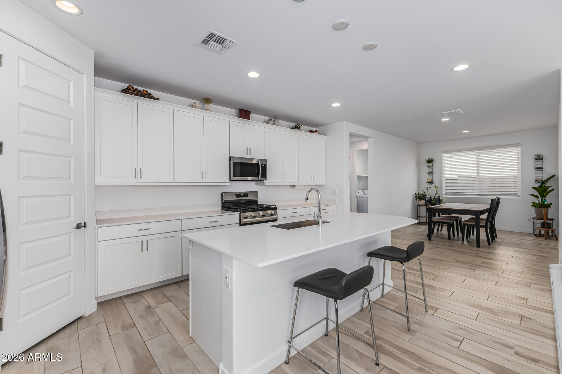 3347 South 156th Avenue Goodyear, AZ 85338 - Photo 14 of 50 a kitchen with cabinets and chairs in it
