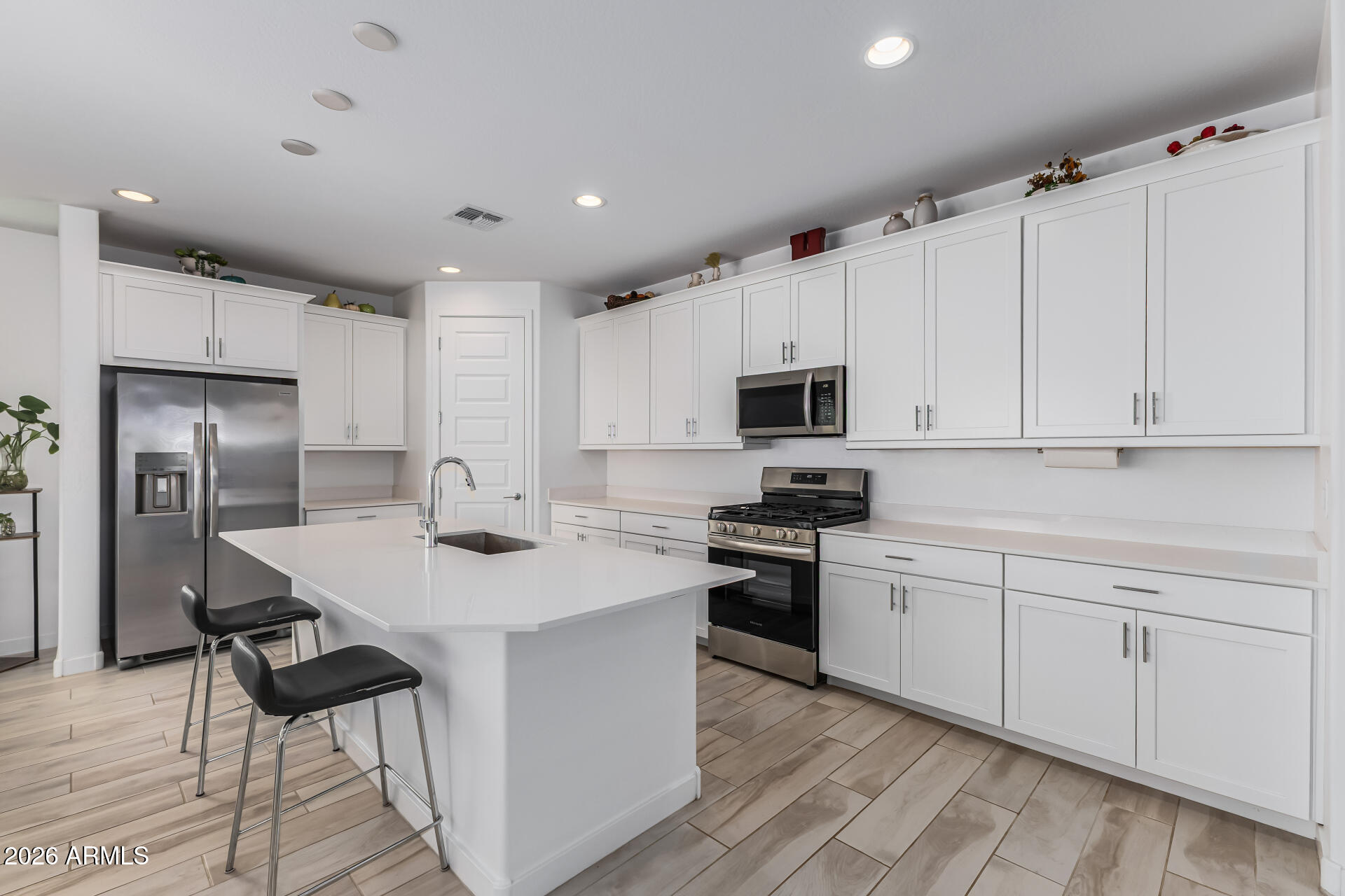 3347 South 156th Avenue Goodyear, AZ 85338 - Photo 15 of 50 a kitchen with white cabinets appliances and sink