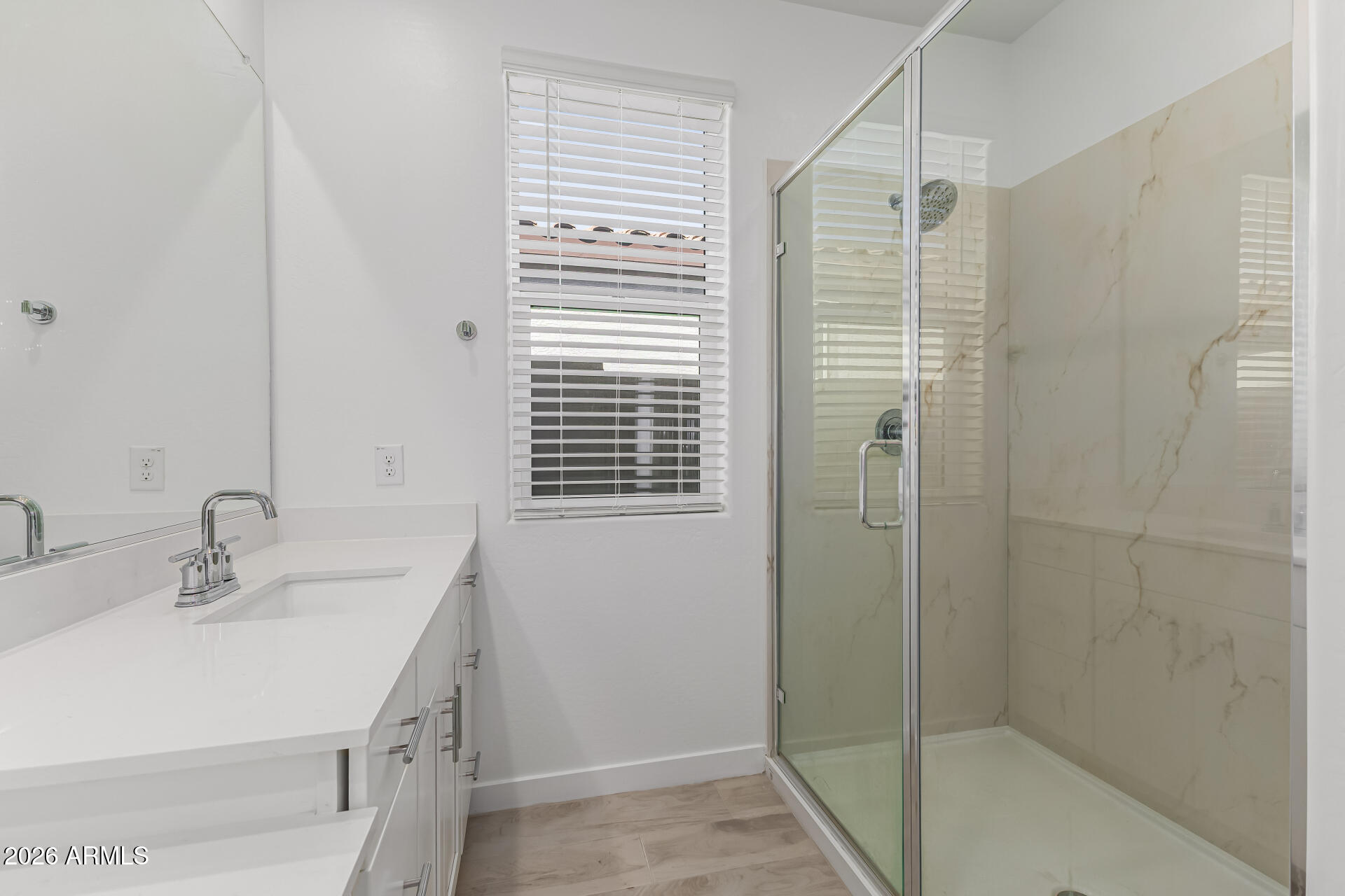 3347 South 156th Avenue Goodyear, AZ 85338 - Photo 22 of 50 a bathroom with a sink a shower and a mirror