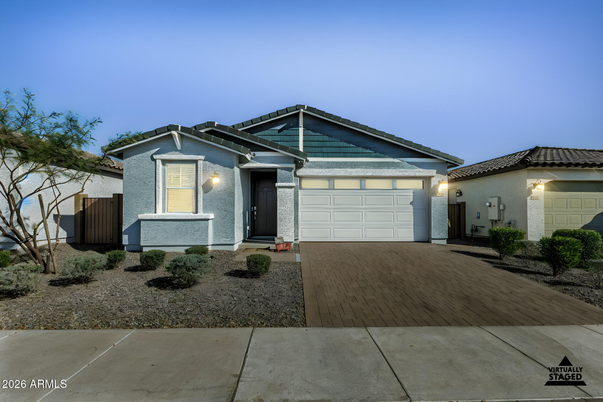3347 South 156th Avenue Goodyear, AZ 85338 - Photo 40 of 50 a front view of a house with a yard and garage