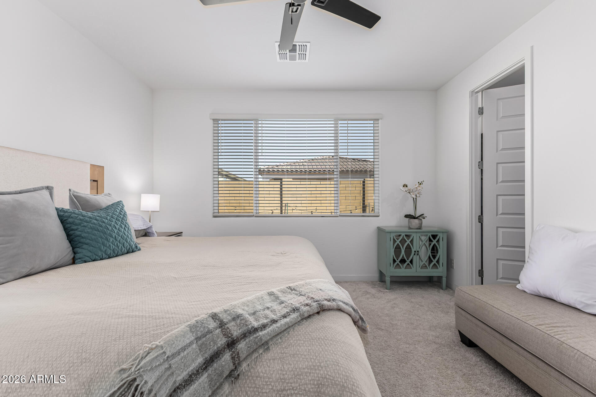 3347 South 156th Avenue Goodyear, AZ 85338 - Photo 4 of 50 a bedroom with a large bed and a couch