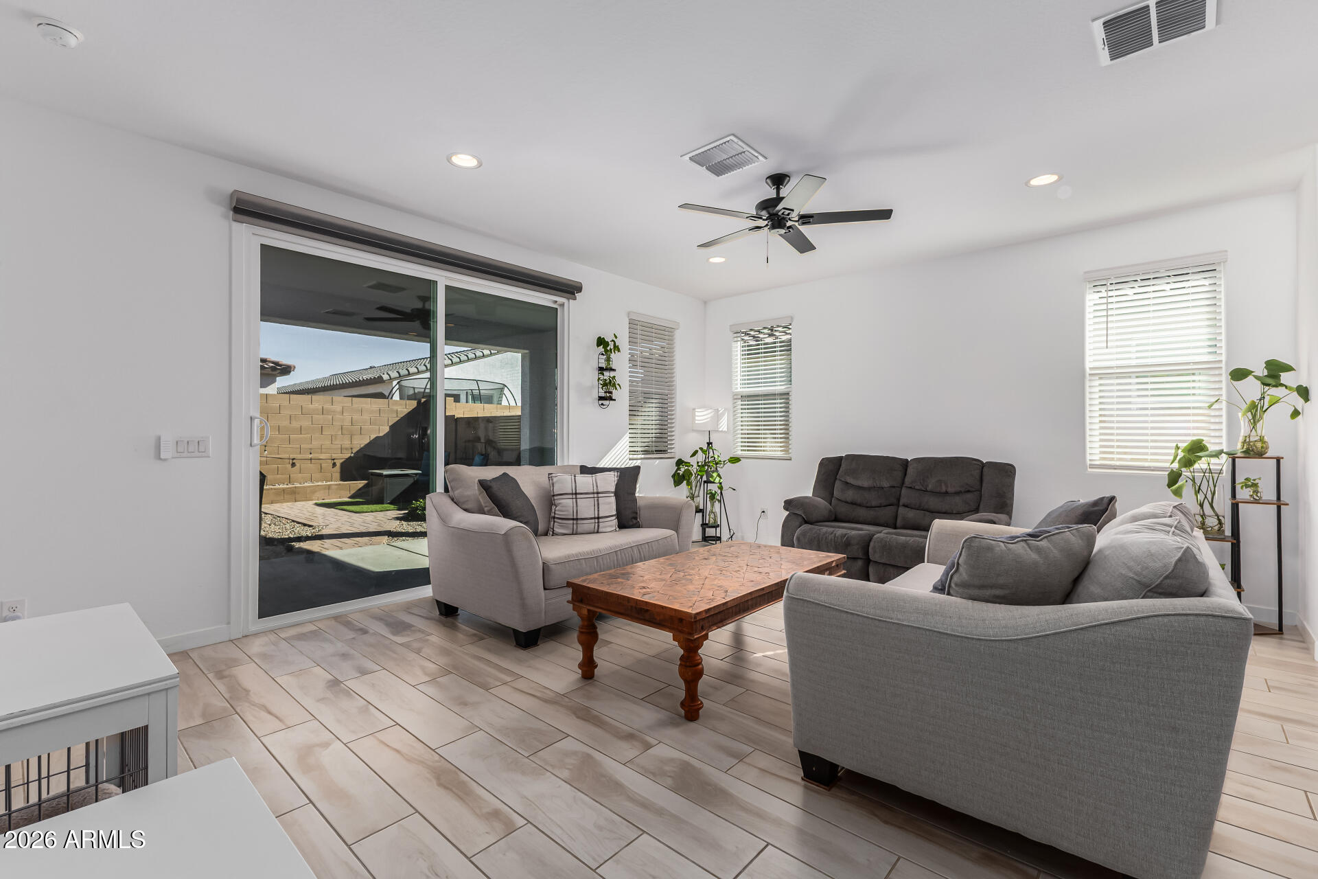 3347 South 156th Avenue Goodyear, AZ 85338 - Photo 7 of 50 a living room with furniture and a large window