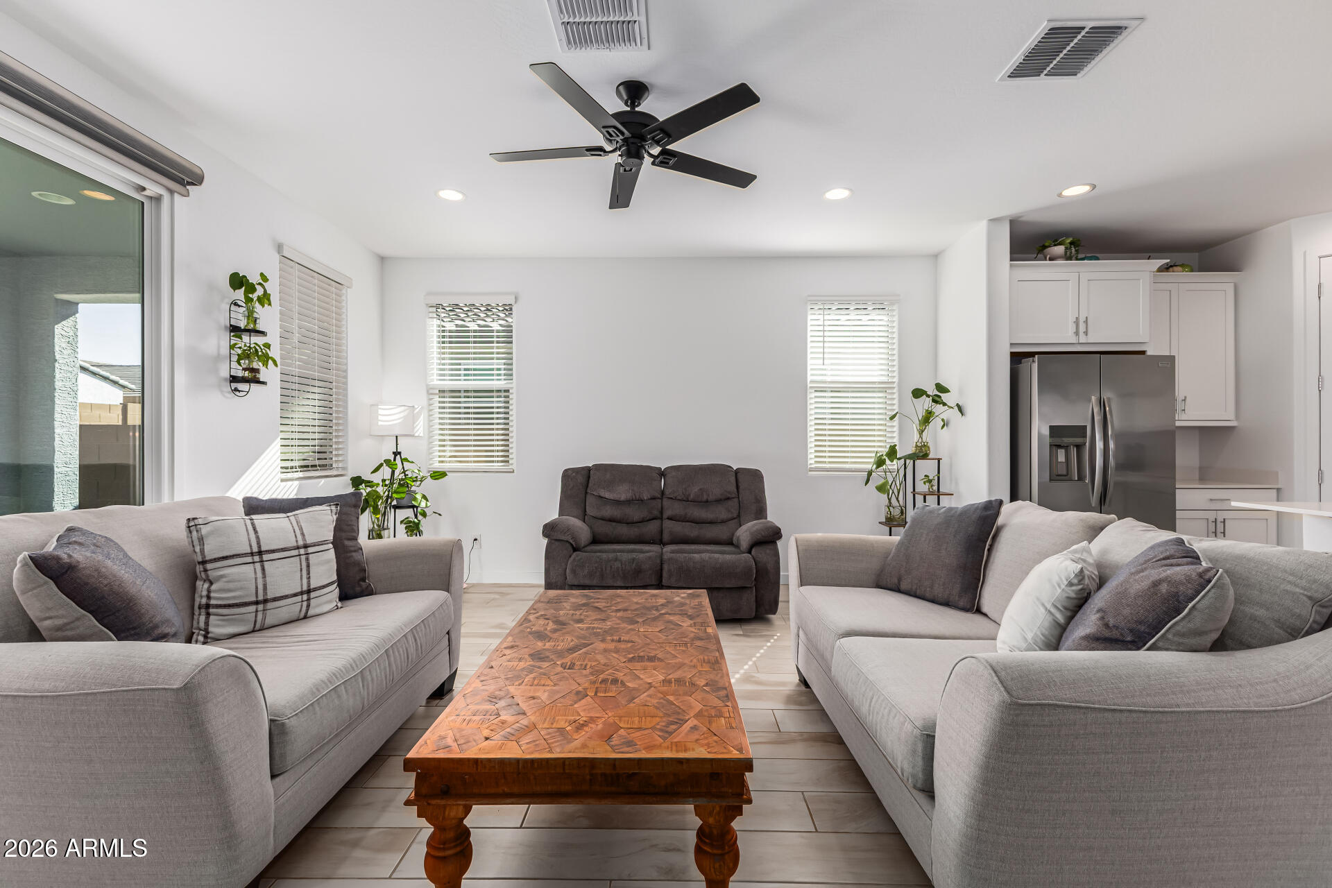3347 South 156th Avenue Goodyear, AZ 85338 - Photo 8 of 50 a living room with furniture or couch and a ceiling fan