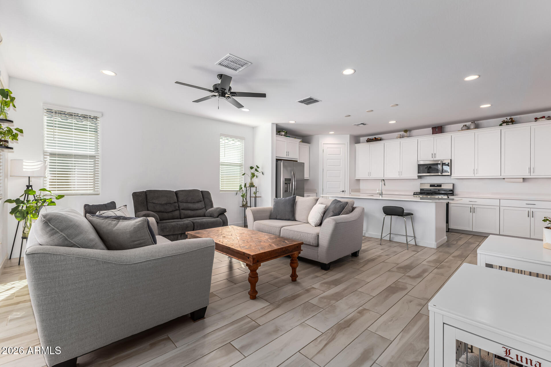 3347 South 156th Avenue Goodyear, AZ 85338 - Photo 9 of 50 a living room with furniture and kitchen view