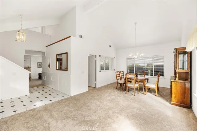 a large kitchen with stainless steel appliances kitchen island granite countertop a refrigerator a stove and a sink