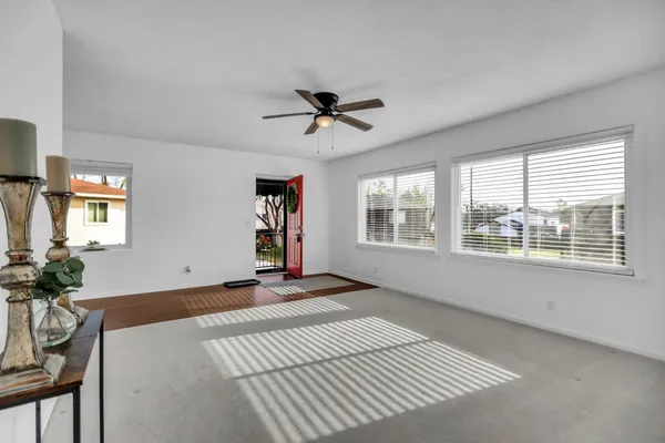 a view of a livingroom with a ceiling fan and window
