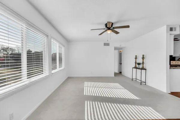 a kitchen with a refrigerator a stove top oven a cabinetry and chandelier