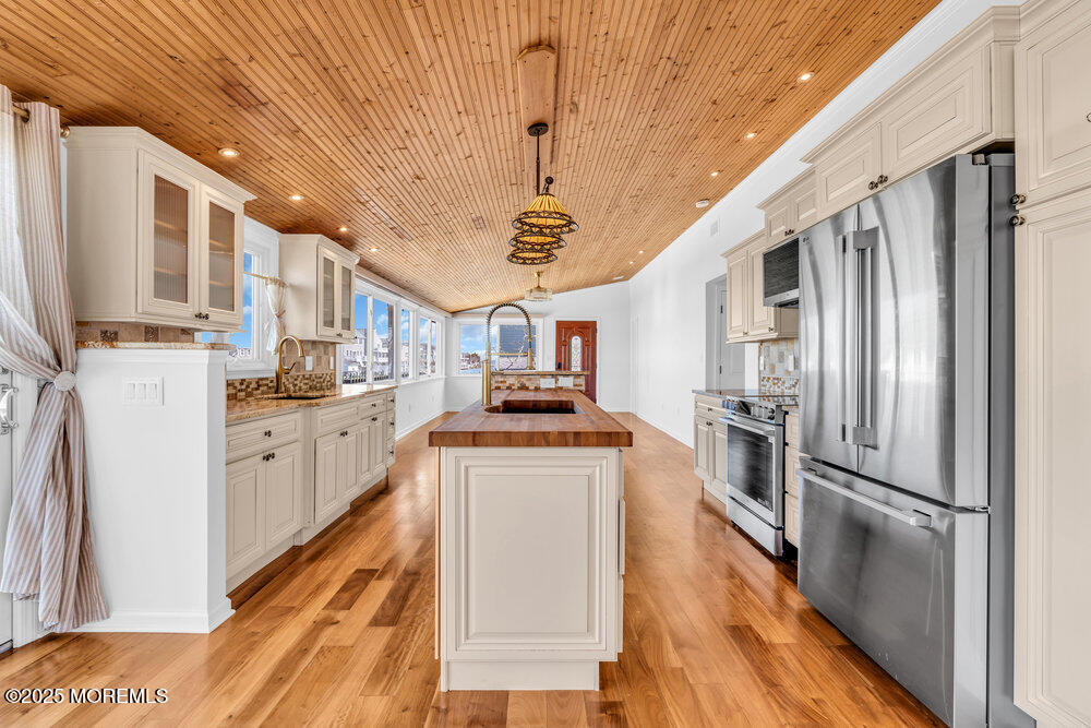 23 Bayview Drive Waretown, NJ 08758 - Photo 21 of 67 a kitchen with stainless steel appliances granite countertop a refrigerator a stove and a sink