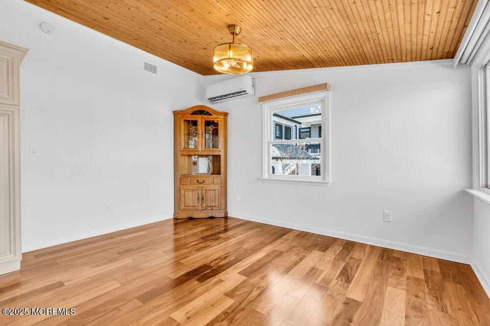 23 Bayview Drive Waretown, NJ 08758 - Photo 22 of 67 a view of an empty room with window and wooden floor