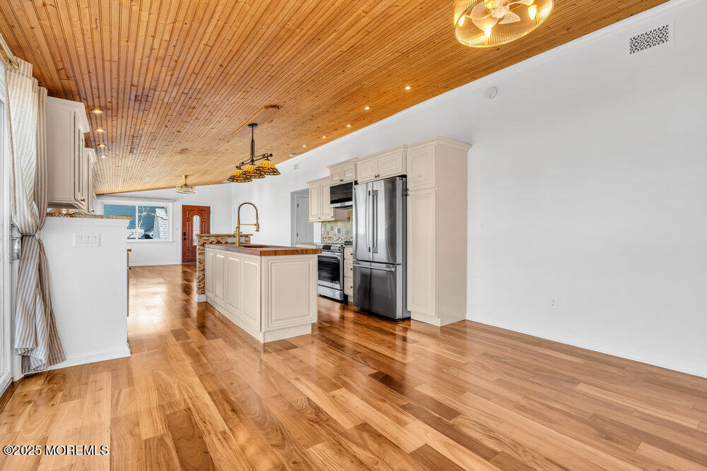 23 Bayview Drive Waretown, NJ 08758 - Photo 23 of 67 a kitchen with stainless steel appliances granite countertop a refrigerator a stove and a wooden floors