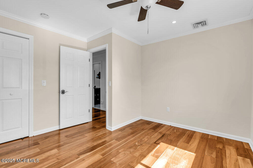 23 Bayview Drive Waretown, NJ 08758 - Photo 28 of 67 an empty room with wooden floor ceiling fan and windows