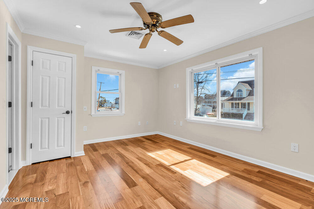 23 Bayview Drive Waretown, NJ 08758 - Photo 31 of 67 a view of an empty room with window and a chandelier fan