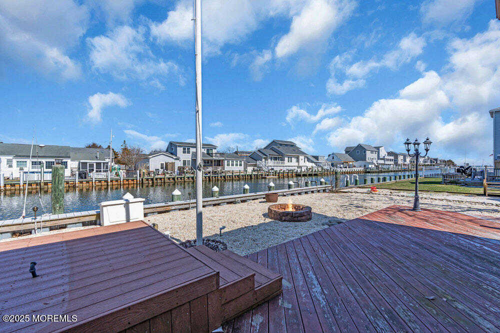 23 Bayview Drive Waretown, NJ 08758 - Photo 48 of 67 a view of a rooftop deck with dining table and chairs