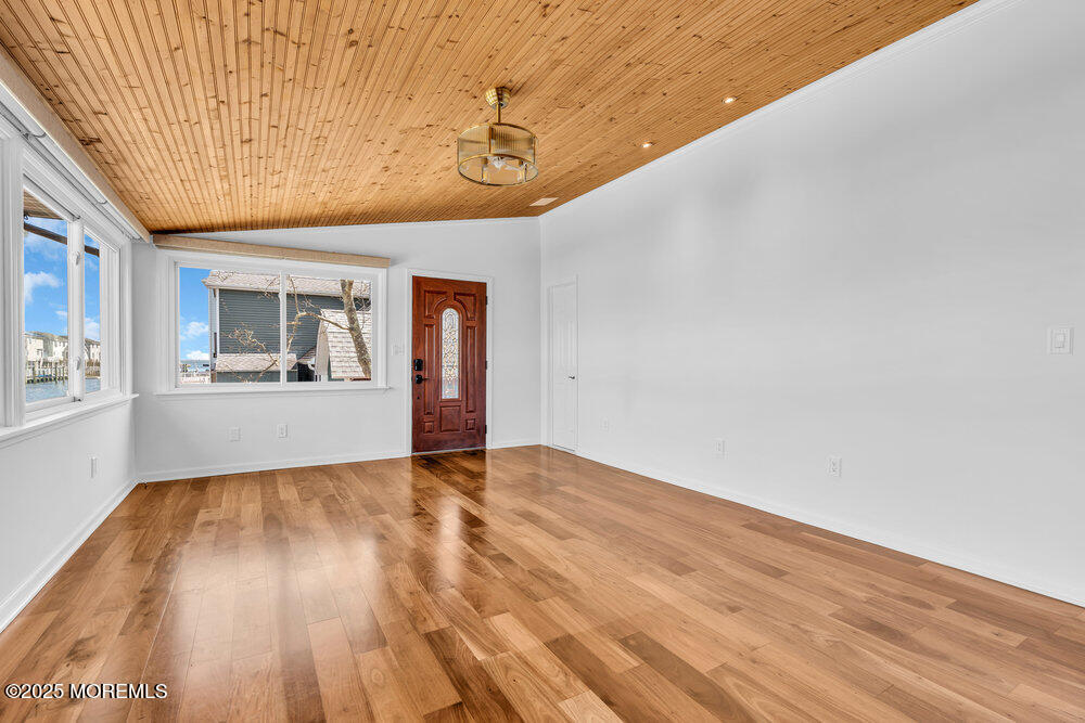 23 Bayview Drive Waretown, NJ 08758 - Photo 5 of 67 a view of empty room with wooden floor and fan