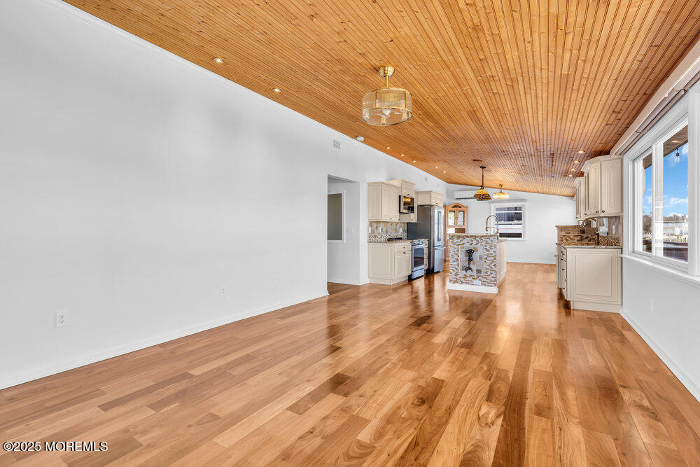23 Bayview Drive Waretown, NJ 08758 - Photo 9 of 67 a view of empty room with wooden floor
