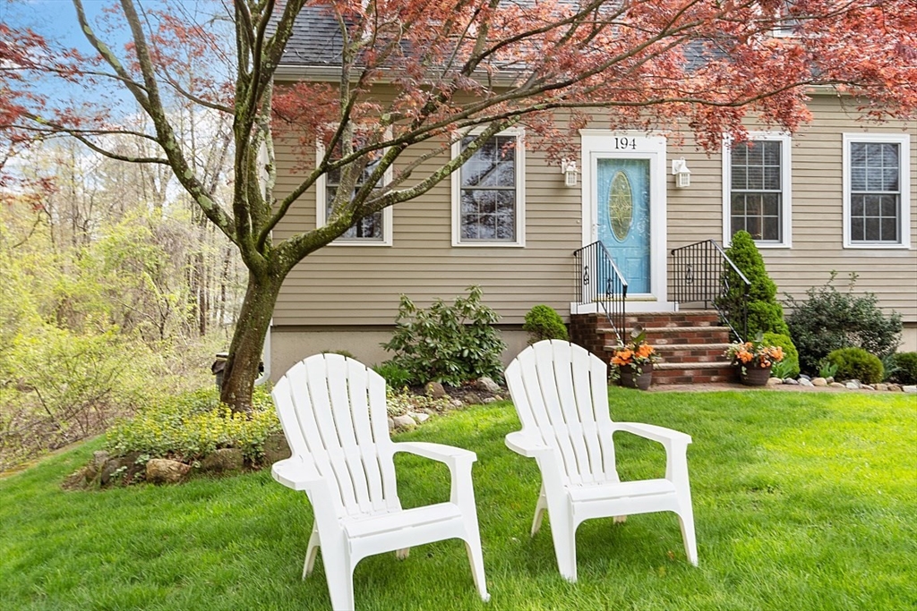 a couple of chairs sitting in backyard of house
