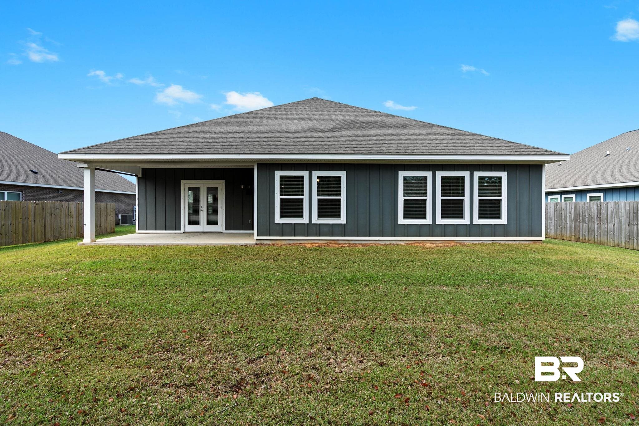 9448 Amethyst Drive Daphne, AL 36526 - Photo 53 of 61 Rear view of house featuring board and batten siding, roof with shingles, a patio area, and french doors