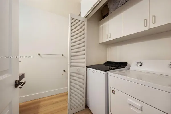 a spacious bathroom with a bathtub sink and mirror