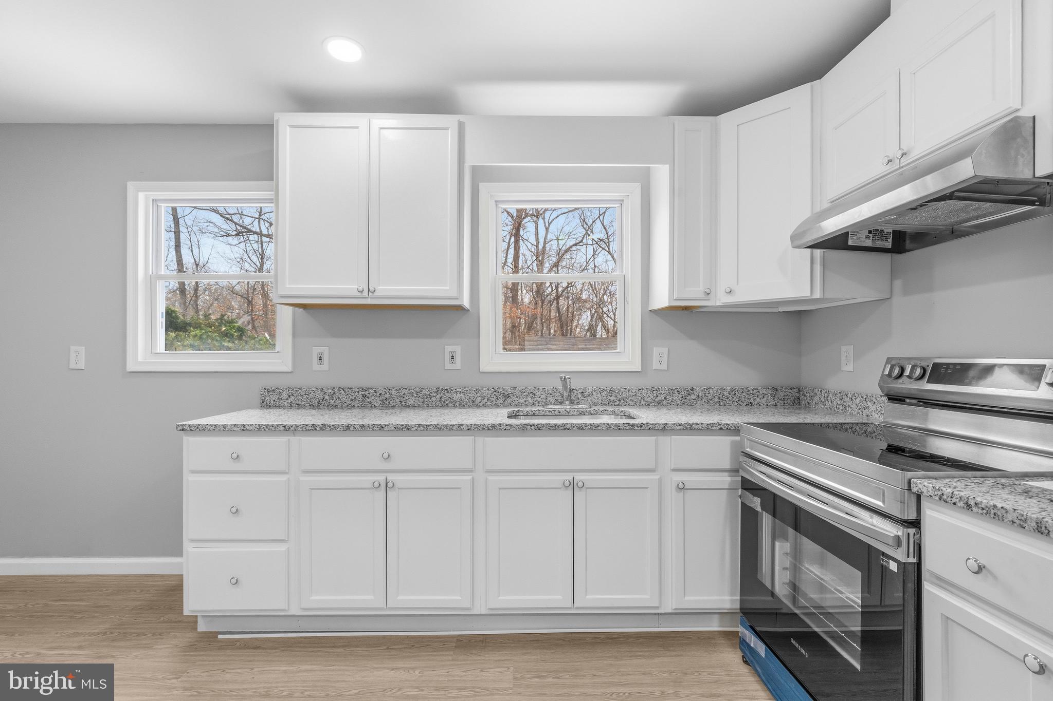 3720 Mt Pleasant Road Waldorf, MD 20601 - Photo 13 of 31 a kitchen with granite countertop white cabinets stainless steel appliances a sink and a window