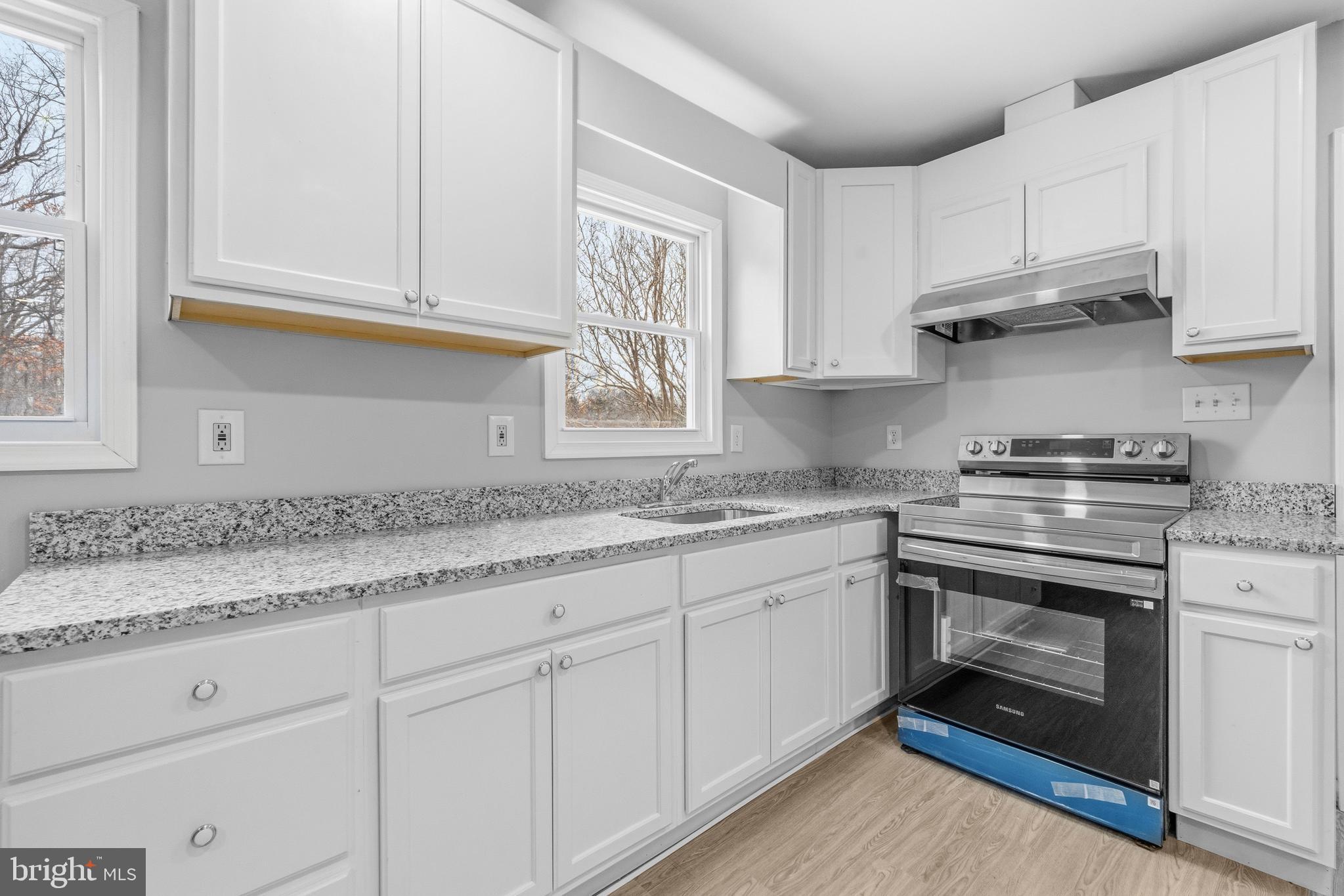 3720 Mt Pleasant Road Waldorf, MD 20601 - Photo 14 of 31 a kitchen with granite countertop white cabinets and white appliances