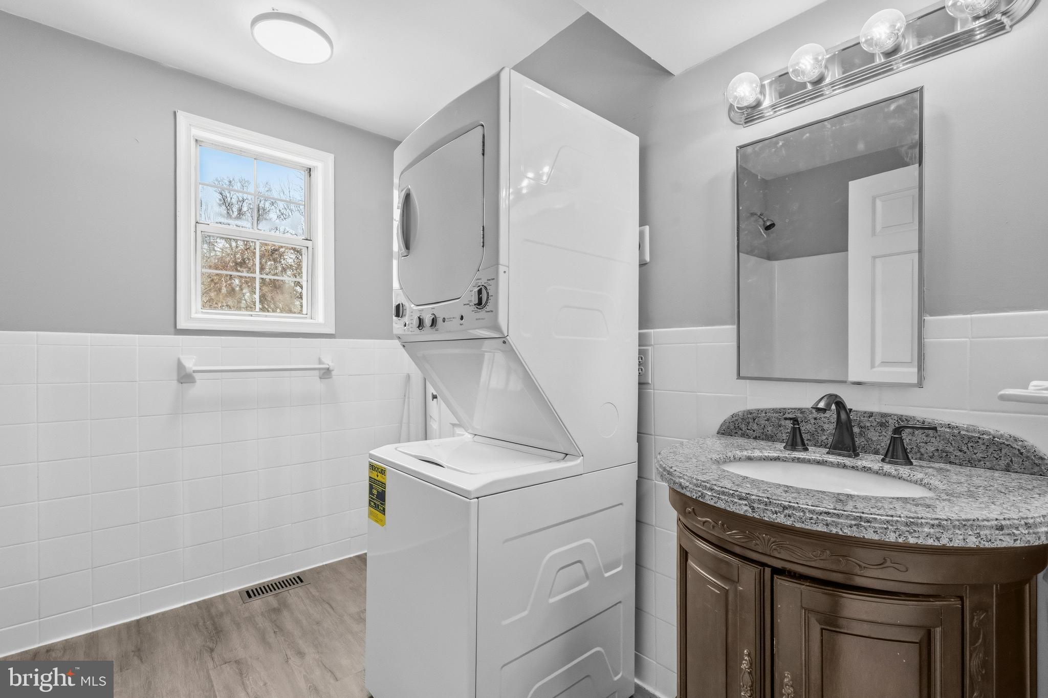 3720 Mt Pleasant Road Waldorf, MD 20601 - Photo 15 of 31 a bathroom with a granite countertop sink a mirror a vanity and a shower