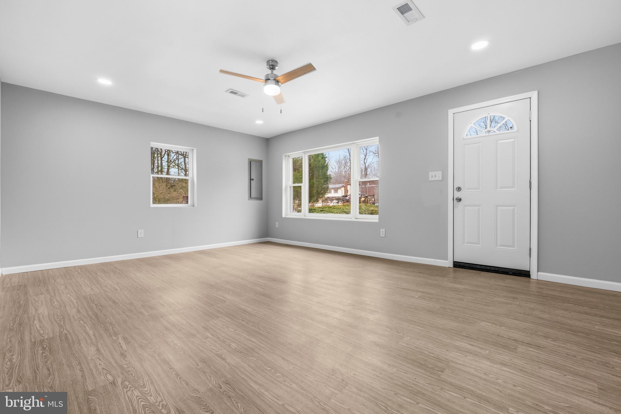 3720 Mt Pleasant Road Waldorf, MD 20601 - Photo 6 of 31 an empty room with wooden floor ceiling fan and windows
