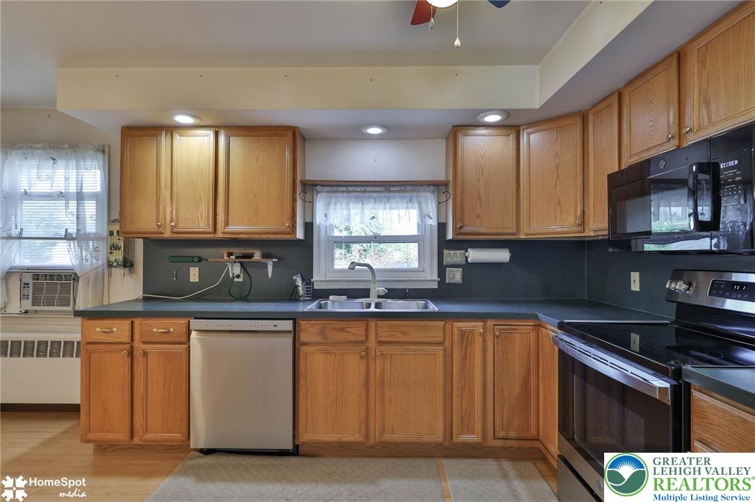3069 Shakespeare Road Bethlehem, PA 18017 - Photo 7 of 50 Well-appointed kitchen featuring ample cabinetry, a double basin sink, and modern stainless steel appliances.