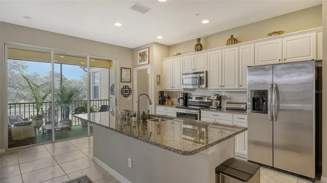 a view of a balcony with chairs and potted plants