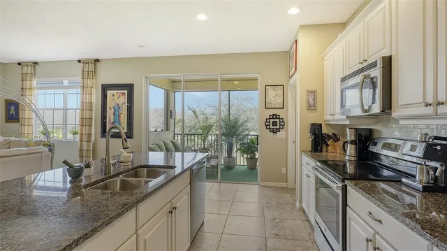 a bedroom with a bed and a flat tv screen on the dresser