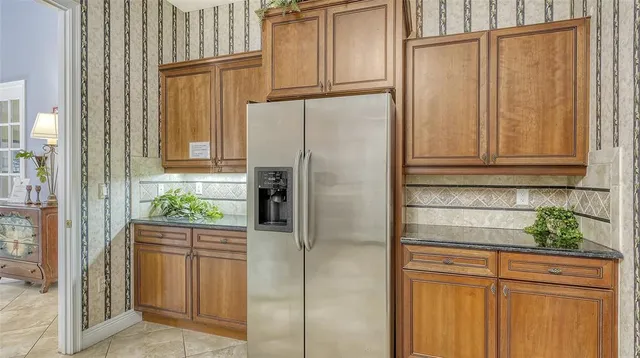 a view of wooden deck and lake with trees in the background