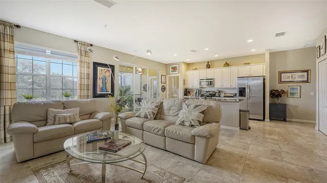 a kitchen with stainless steel appliances granite countertop a sink a stove and a refrigerator