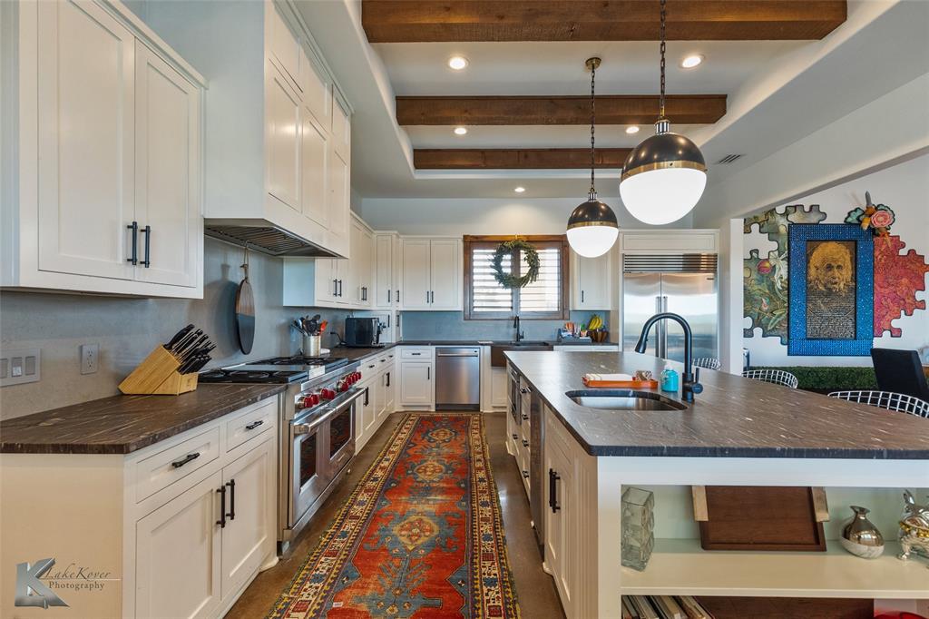 226 Rabbit Run Tuscola, TX 79562 - Photo 14 of 40 a kitchen with stainless steel appliances granite countertop a stove and cabinets
