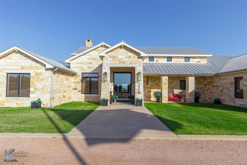 226 Rabbit Run Tuscola, TX 79562 - Photo 3 of 40 a front view of a house with a yard and garage