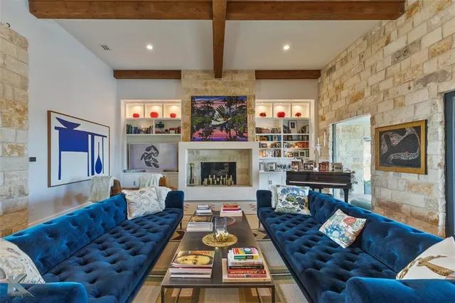 a living room with furniture a flat screen tv and a fireplace