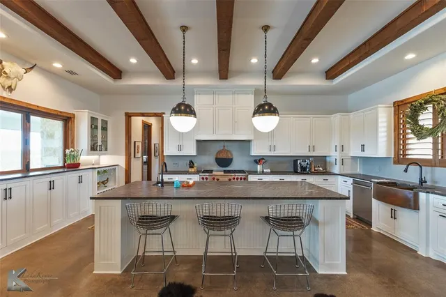 a large kitchen with a table and chairs