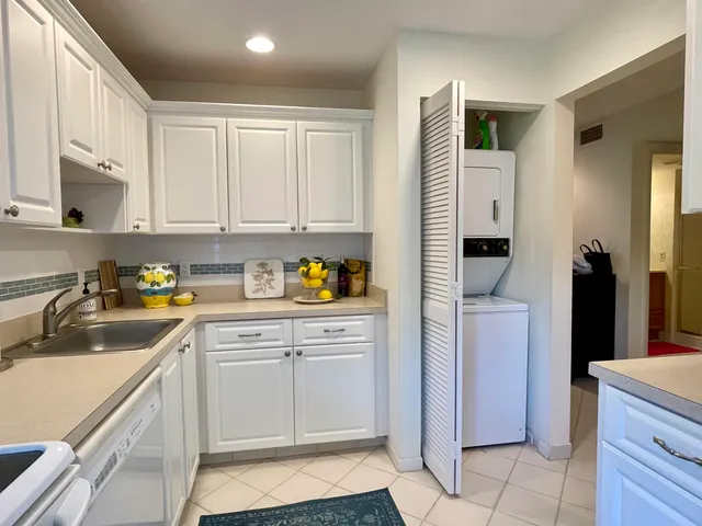 a kitchen with a sink cabinets and refrigerator