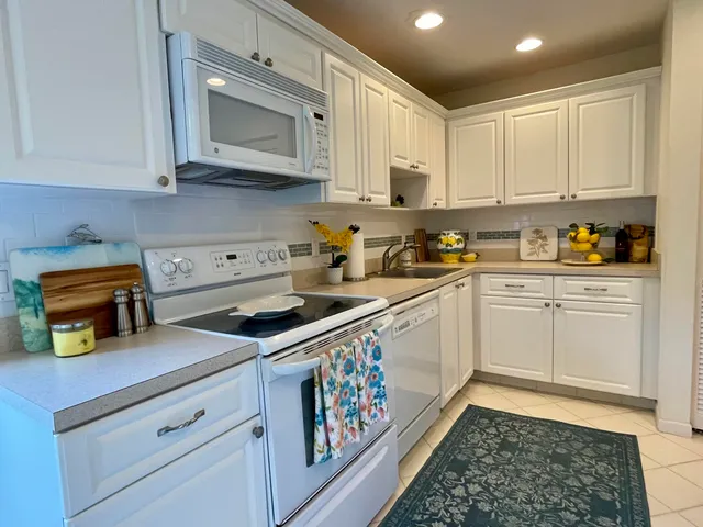 a kitchen with stainless steel appliances granite countertop a sink and cabinets