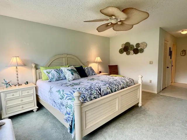a bedroom with a bed and ceiling fan