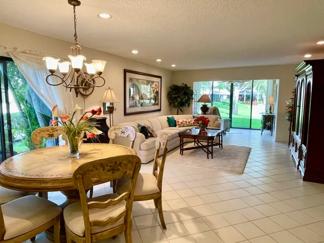 a view of a dining room with furniture wooden floor and chandelier