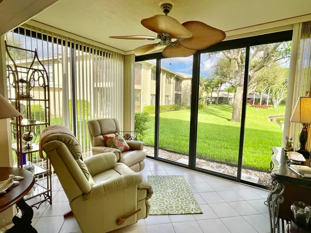 a living room with furniture and a floor to ceiling window