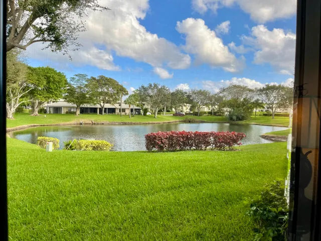 a view of a lake with houses in the back