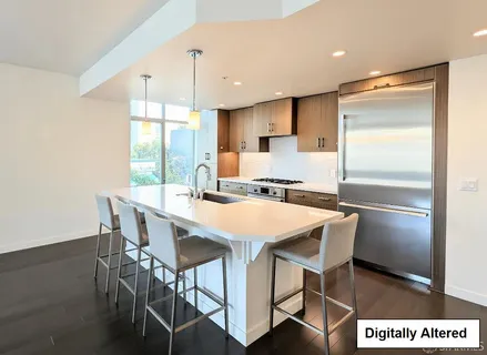 a kitchen with kitchen island a table and chairs in it