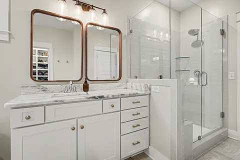 a bathroom with a shower sink and mirror