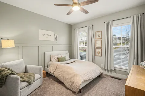 a bedroom with a bed couch and window