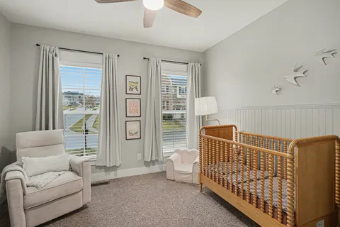 a bedroom with furniture and a large window