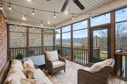 a balcony with furniture and a ceiling fan