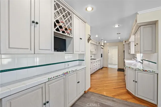 a kitchen with stainless steel appliances white cabinets and a sink