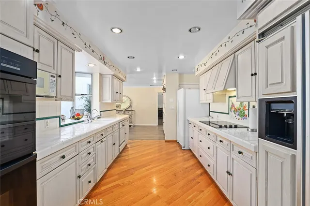 a large kitchen with stainless steel appliances kitchen island granite countertop a lot of counter space and a sink