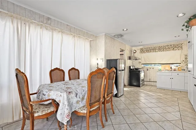 a kitchen with stainless steel appliances kitchen island granite countertop a table and chairs