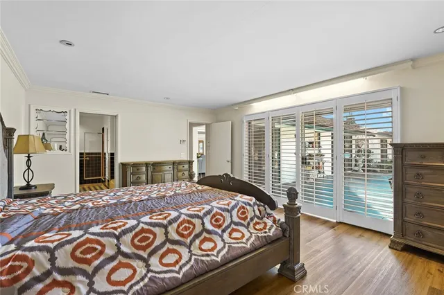 a bedroom with a large bed and a dresser